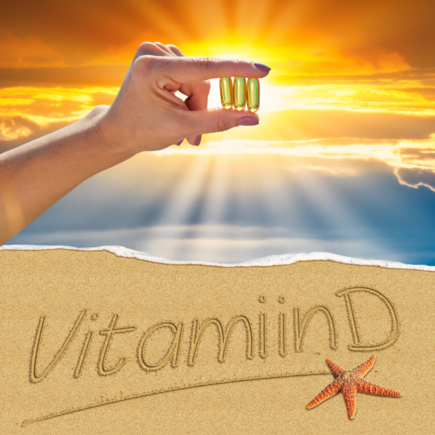 Vitamiin D3 kapslid päikesevalguses liivaranna taustal.